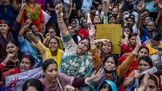 Members of the Bangladeshi Hindu community hold banners and chant slogans against violence targeting the country's minorities during a protest in Dhaka on August 9, 2024, days after a student-led uprising ended the 15-year rule of Sheikh Hasina.(AFP)