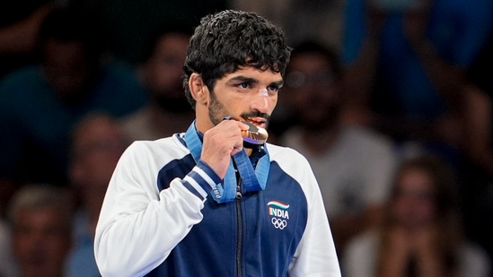 Bronze medalist India's Aman Sehrawat poses for photos at the podium.(PTI)