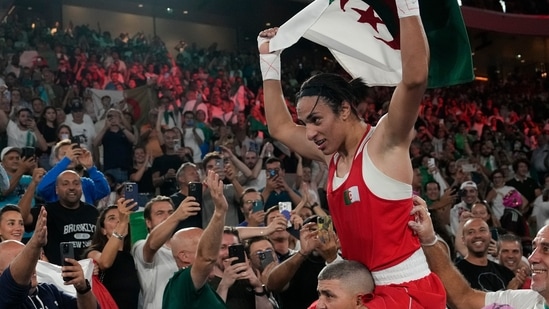 Algeria's Imane Khelif celebrates after defeating China's Yang Liu to win gold in their women's 66 kg final boxing match at the 2024 Summer Olympics(AP)