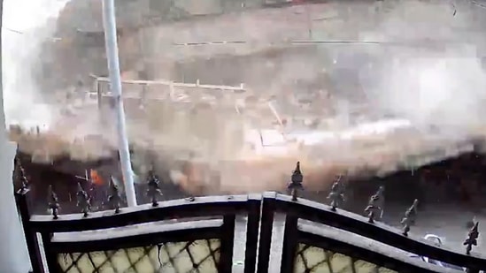 CCTV footage shared by PTI captured the building's collapse on camera amidst continuous rain.