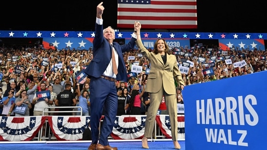 Minnesota Governor and Democratic vice presidential candidate Tim Walz (L) gestures alongside US Vice President and Democratic presidential candidate Kamala Harris during a campaign event at Desert Diamond Arena in Glendale, Arizona, on August 9, 2024.(AFP / Robyn Beck)