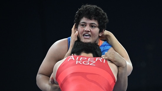 Kyrgyzstan's Aiperi Medet Kyzy (red) wrestles India's Reetika Reetika (blue) in their women's freestyle 76kg wrestling quarter-final match at the Champ-de-Mars Arena during the Paris 2024 Olympic Games, in Paris (AFP)