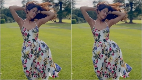 In a new video, Janhvi Kapoor embraced spring in a spaghetti strap midi dress. The ivory ensemble is by Dolce & Gabbana and features a colourful floral pattern, a halter neckline, a sweetheart neckline, a fitted bodice, and a flared skirt. (Instagram)