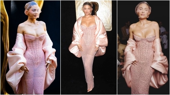 This year, Kylie attended the Schiaparelli haute couture show in a dress that embraced the pink bridal trend. The influencer wore a crystal-dotted, baby-pink corset dress accentuating her world-famous enviable body. She styled the sheer, strapless ensemble with thigh-high stockings, pink heels, a voluminous silk jacket, and a sheer head covering.&nbsp;(Instagram)