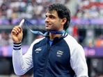 India's Javelin thrower Neeraj Chopra poses for a picture with his silver medal. India's Javelin thrower Neeraj Chopra poses for a picture with his silver medal.