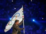 Tom Cruise carries the Olympic flag during the 2024 Summer Olympics closing ceremony at the Stade de France(AP)