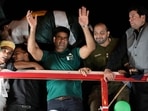 Men's javelin gold medalist, Arshad Nadeem, of Pakistan, centre, waves to Pakistani people outside the Allama Iqbal International Airport, Lahore during his arriving, in Lahore, Pakistan, Sunday, Aug. 11