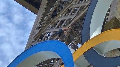 In this photo provided by Nicky Worlock, a man climbs the Eiffel Tower, during the 2024 Summer Olympics, Sunday, Aug. 11, 2024, in Paris France. (AP)