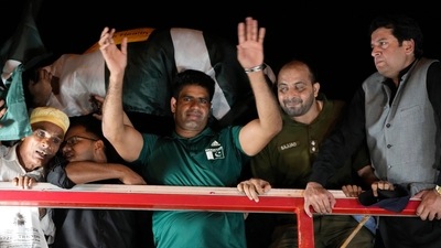 Men's javelin gold medalist, Arshad Nadeem, of Pakistan, centre, waves to Pakistani people outside the Allama Iqbal International Airport, Lahore during his arriving, in Lahore, Pakistan, Sunday, Aug. 11 (AP) Men's javelin gold medalist, Arshad Nadeem, of Pakistan, centre, waves to Pakistani people outside the Allama Iqbal International Airport, Lahore during his arriving, in Lahore, Pakistan, Sunday, Aug. 11 (AP)