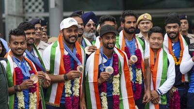 Paris Olympics bronze medallist Indian hockey players pose for photos on their arrival in India. (PTI) Paris Olympics bronze medallist Indian hockey players pose for photos on their arrival in India. (PTI)