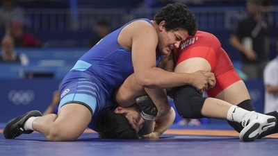 Reetika Hooda (in blue) in action against Kyrgyzstan's Aiperi Medet Kyzy. (HT_PRINT) Reetika Hooda (in blue) in action against Kyrgyzstan's Aiperi Medet Kyzy. (HT_PRINT)