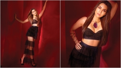 Kriti Sanon wore all-black ensembles for the shoot. The first look features the actor in a bralette and ruffled skirt set. While the blouse features a netted nude sheer bodice, a plunging neckline, and a fitted bust, the skirt has a high-rise waist, tiered tulle ruffles with a see-through silhouette, a back slit, and a maxi length. She paired the ensemble with a statement necklace, a gold armband, black pumps, smoky eyes, darkened brows, pink lips, and mascara on the lashes. (Instagram) Kriti Sanon wore all-black ensembles for the shoot. The first look features the actor in a bralette and ruffled skirt set. While the blouse features a netted nude sheer bodice, a plunging neckline, and a fitted bust, the skirt has a high-rise waist, tiered tulle ruffles with a see-through silhouette, a back slit, and a maxi length. She paired the ensemble with a statement necklace, a gold armband, black pumps, smoky eyes, darkened brows, pink lips, and mascara on the lashes. (Instagram)