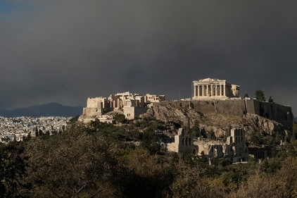 The Parthenon temple atop the Acropolis hill as smoke from a wildfire in the village of Varnava is seen, as its blankets Athens, Greece, August 11, 2024. (Reuters)