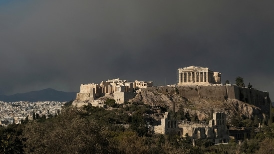 The Parthenon temple atop the Acropolis hill as smoke from a wildfire in the village of Varnava is seen, as its blankets Athens, Greece, August 11, 2024.(Reuters)