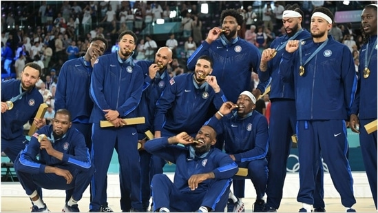 USA's men's basketball team poses with the gold medal at Paris Olympics(AP)