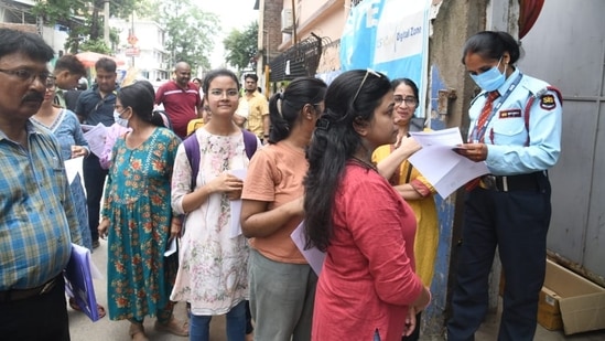 Candidates go through the documents of candidates before they entered the exam hall to appear for NEET PG Exam 2024(Santosh Kumar)