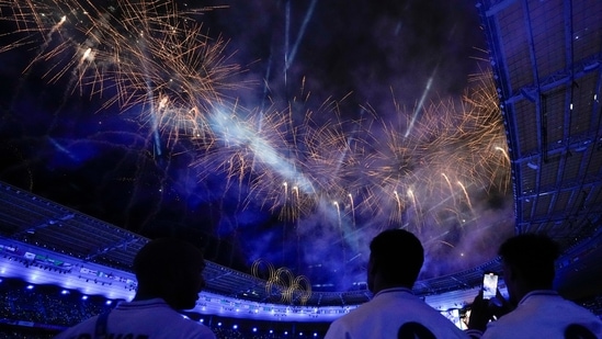 Athletes from the United States watch as fireworks explode during the 2024 Summer Olympics closing ceremony at the Stade de France(AP)