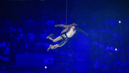 Tom Cruise is lowered on the Stade de France during the 2024 Summer Olympics closing ceremony(AP)