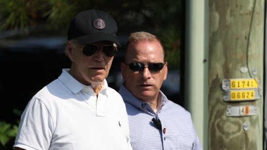 US President Joe Biden (L) departs the beach on August 10, 2024, in Rehoboth Beach, Delaware. (AFP)