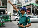A police personnel controls traffic at a road intersection after the Bangladeshi police force resumed duty, in Dhaka. A police personnel controls traffic at a road intersection after the Bangladeshi police force resumed duty, in Dhaka.