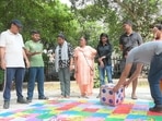 Mayur Vihar Phase 3 residents participate in a game of Snakes and Ladders at the Society Socials event.