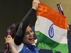 Manu Bhaker celebrates with the Indian flag after winning a medal. Manu Bhaker celebrates with the Indian flag after winning a medal.