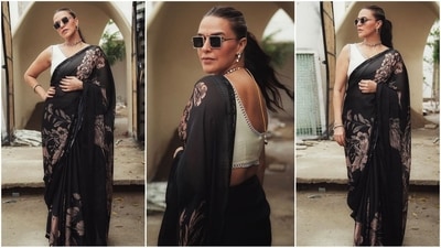 Neha Dhupia recently wowed everyone in a stunning black saree adorned with a striking floral print, perfectly paired with a chic white V-neck sleeveless blouse. She elevated the look with black square sunglasses, a statement choker necklace, and matching earrings, serving up some serious ethnic fashion goals. (Instagram)