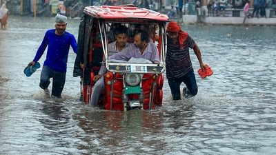 A vehicle moves through a waterlogged Sikar road following heavy monsoon rain in Jaipur on Monday. (PTI) A vehicle moves through a waterlogged Sikar road following heavy monsoon rain in Jaipur on Monday. (PTI)