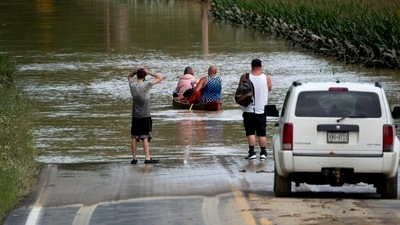Eric Combs, Maverick Knight and Michelle Knight paddle away as they traverse high water along Canisteo River Road in Canisteo, N.Y., Friday, Aug. 9, 2024, after remnants of Tropical Storm Debby swept through the area. (AP Photo/Craig Ruttle)(AP08_10_2024_000058B) (AP) Eric Combs, Maverick Knight and Michelle Knight paddle away as they traverse high water along Canisteo River Road in Canisteo, N.Y., Friday, Aug. 9, 2024, after remnants of Tropical Storm Debby swept through the area. (AP Photo/Craig Ruttle)(AP08_10_2024_000058B) (AP)