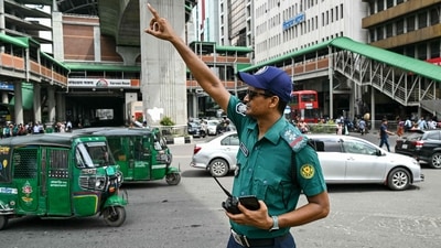 A police personnel controls traffic at a road intersection after the Bangladeshi police force resumed duty, in Dhaka. (AFP) A police personnel controls traffic at a road intersection after the Bangladeshi police force resumed duty, in Dhaka. (AFP)
