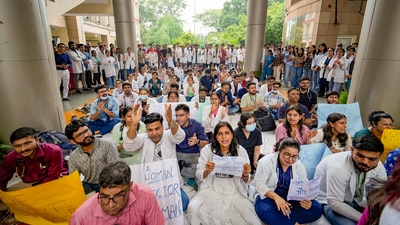 Medics stage a protest against the sexual assault and murder of a postgraduate trainee doctor in Kolkata (PTI) Medics stage a protest against the sexual assault and murder of a postgraduate trainee doctor in Kolkata (PTI)