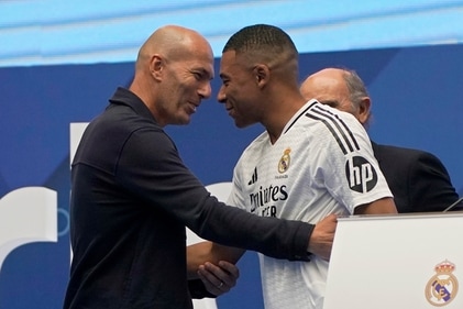 Kylian Mbappe, of France, embraces French legend Zinedine Zidane, left, while being presented to fans as a new Real Madrid player at the Santiago Bernabeu (AP) Kylian Mbappe, of France, embraces French legend Zinedine Zidane, left, while being presented to fans as a new Real Madrid player at the Santiago Bernabeu (AP)