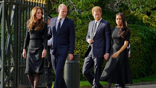 FILE - Britain's Prince William, second left, Kate, Princess of Wales, left, Britain's Prince Harry, second right, and Meghan, Duchess of Sussex view the floral tributes for the late Queen Elizabeth II outside Windsor Castle, in Windsor, England on Sept. 10, 2022. (AP Photo/Martin Meissner, File)(AP)