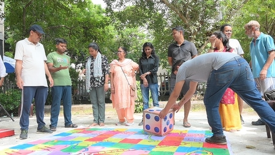 Mayur Vihar Phase 3 residents participate in a game of Snakes and Ladders at the Society Socials event.