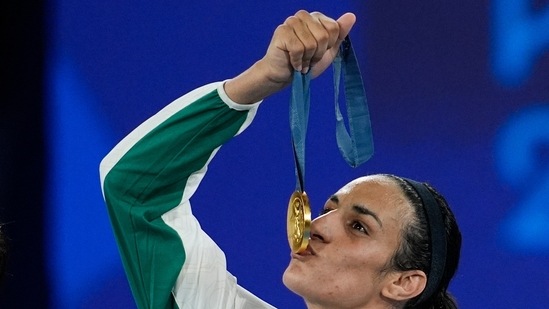 Gold medalist Algeria's Imane Khelif kisses her gold medal for the women's 66 kg final boxing match(AP) Gold medalist Algeria's Imane Khelif kisses her gold medal for the women's 66 kg final boxing match(AP)