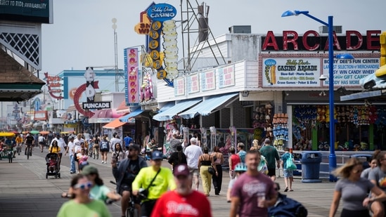 Visitors stroll past arcades on the boardwalk in Wildwood, N.J. US Myrtle Beach to Wildwood: Waterfront shops see surge in summer tourist traffic and sales (AP Photo/Matt Rourke)