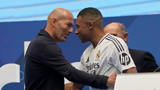 Kylian Mbappe, of France, embraces French legend Zinedine Zidane, left, while being presented to fans as a new Real Madrid player at the Santiago Bernabeu