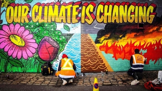 Street artists paint a mural on climate change. (AFP File Photo)