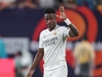 Real Madrid forward Vinicius Junior (7) gestures to fans during the second half of an international friendly against Barcelona