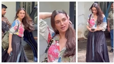 Aditi Rao Hydari sported an off-white satin shirt with colourful floral print, exuding classy elegance with a feminine flair. She contrasted this feminine elegance with a chic long pleated skirt and oversized belt. She accessorised with an oversized moss green bag. The actor fused whimsical and romantic element of her outfit with a contemporary aesthetic for an effortless modern feminine look. ( Instagram/@varindertchawla)