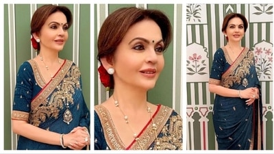 Nita Ambani looked stunning in a blue saree with intricate golden embroidery at the borders. Her hair was tucked in a neat bun with a rose. For accessories, she opted for a long pendant necklace, with dazzling diamond ear studs, rings and bangles.&nbsp; (Instagram/@sunita_shekhawat_jaipur)