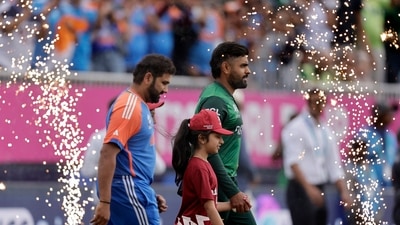 Pakistan's captain Babar Azam, right, and India's captain Rohit Sharma walk into the field before the start of the ICC Men's T20 World Cup cricket match (PTI) Pakistan's captain Babar Azam, right, and India's captain Rohit Sharma walk into the field before the start of the ICC Men's T20 World Cup cricket match (PTI)