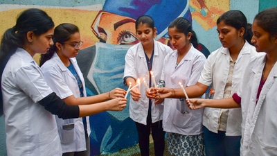 Medical students and doctors take part in a candlelight protest against the sexual assault and murder of a postgraduate trainee doctor in Kolkata. (PTI) Medical students and doctors take part in a candlelight protest against the sexual assault and murder of a postgraduate trainee doctor in Kolkata. (PTI)
