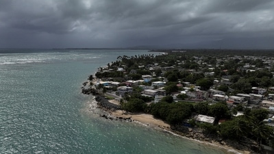 A drone view shows storm clouds over a coastal community as Tropical Storm Ernesto approaches Loiza, Puerto Rico, August 13, 2024.  REUTERS/Ricardo Arduengo (REUTERS)