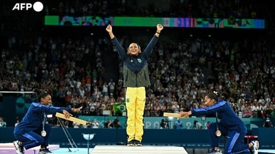 US' Simone Biles (silver), Brazil's Rebeca Andrade (gold) and US' Jordan Chiles (bronze) pose during the podium ceremony for the artistic gymnastics women's floor exercise event of the Paris 2024 Olympic Games at the Bercy Arena in Paris. AFP photographer Gabriel Bouys described it as "a super classy gesture" and the symbol of sisterhood quickly went viral. "I saw the Americans talking to each other before the medal ceremony, I suspected that something was going to happen and I decided to broaden the scope", he said. "I'm not the one making the photo, they are. It was a super nice moment," he said, adding that it reflected the overall atmosphere of the Games. US' Simone Biles (silver), Brazil's Rebeca Andrade (gold) and US' Jordan Chiles (bronze) pose during the podium ceremony for the artistic gymnastics women's floor exercise event of the Paris 2024 Olympic Games at the Bercy Arena in Paris. AFP photographer Gabriel Bouys described it as "a super classy gesture" and the symbol of sisterhood quickly went viral. "I saw the Americans talking to each other before the medal ceremony, I suspected that something was going to happen and I decided to broaden the scope", he said. "I'm not the one making the photo, they are. It was a super nice moment," he said, adding that it reflected the overall atmosphere of the Games.