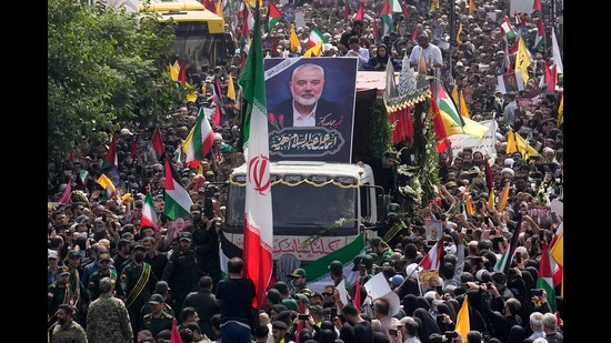 FILE - Iranians follow a truck, center, carrying the coffins of Hamas leader Ismail Haniyeh and his bodyguard during their funeral ceremony at Enqelab-e-Eslami (Islamic Revolution) Sq. in Tehran, Iran, Thursday, Aug. 1, 2024. (AP Photo/Vahid Salemi, File) (AP)