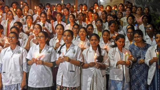 Junior Doctors of Gandhi Medical College in Hyderabad take part in a candle light march in protest against rape and killing of a trainee doctor at Kolkata's RG Kar Medical College on Monday. (PTI)