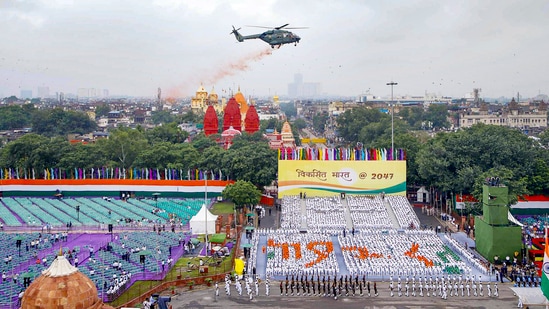 Helicopter showers flower petals on participants of the Dress Rehearsal for Independence Day(Photo: PTI)