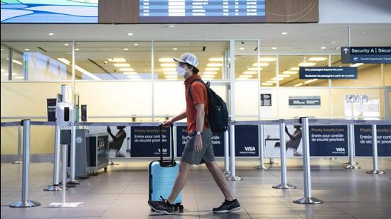 People walk through Billy Bishop Airport in Toronto on July 19. (AP)