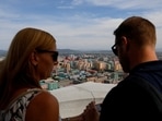 Foreign tourists take photos of the city skyline from the viewing deck at Juche Tower in Pyongyang, North Korea. Picture taken September 11, 2018. North Korea to open border for foreign tourists in December 2024, tour operators say (REUTERS/Danish Siddiqui/File Photo)